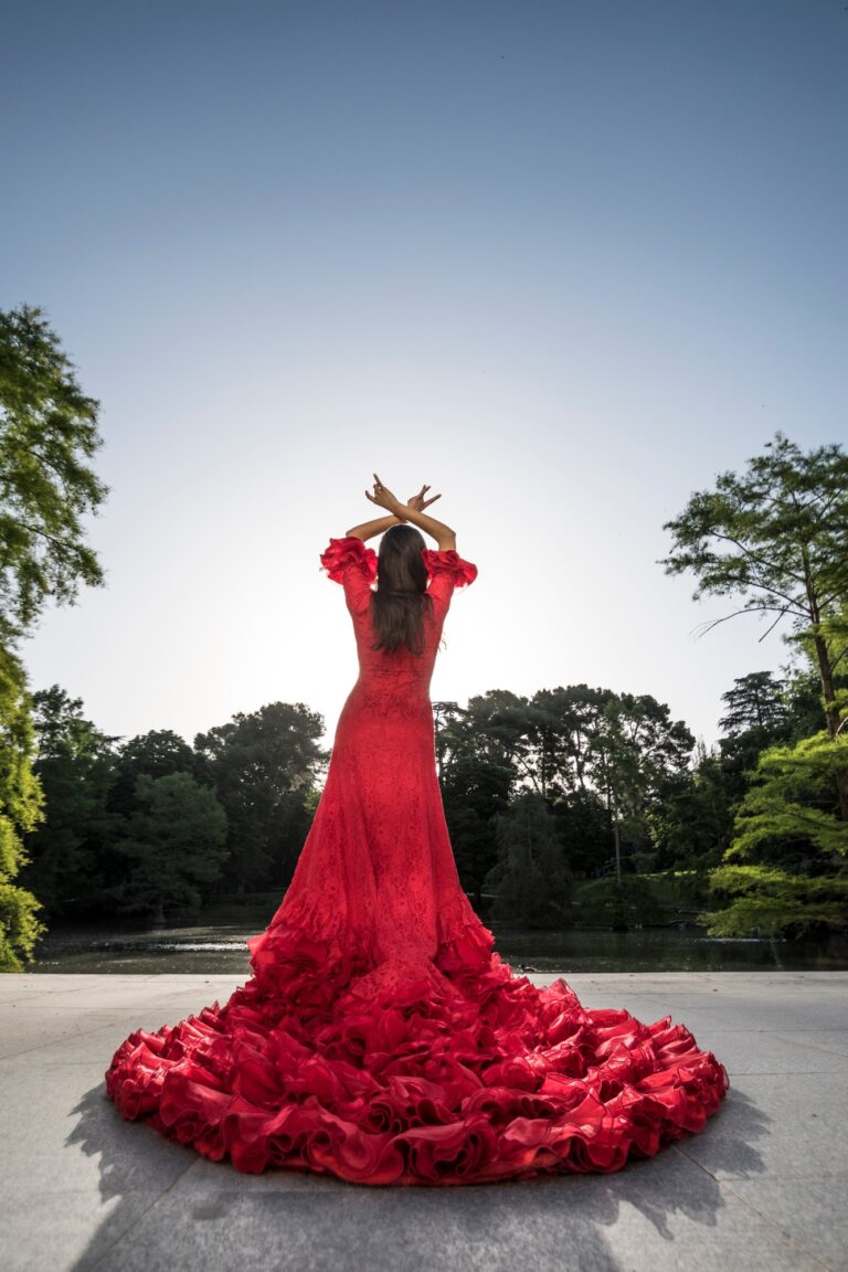 Back view of woman dressed in red dancing flamenco on a terrace